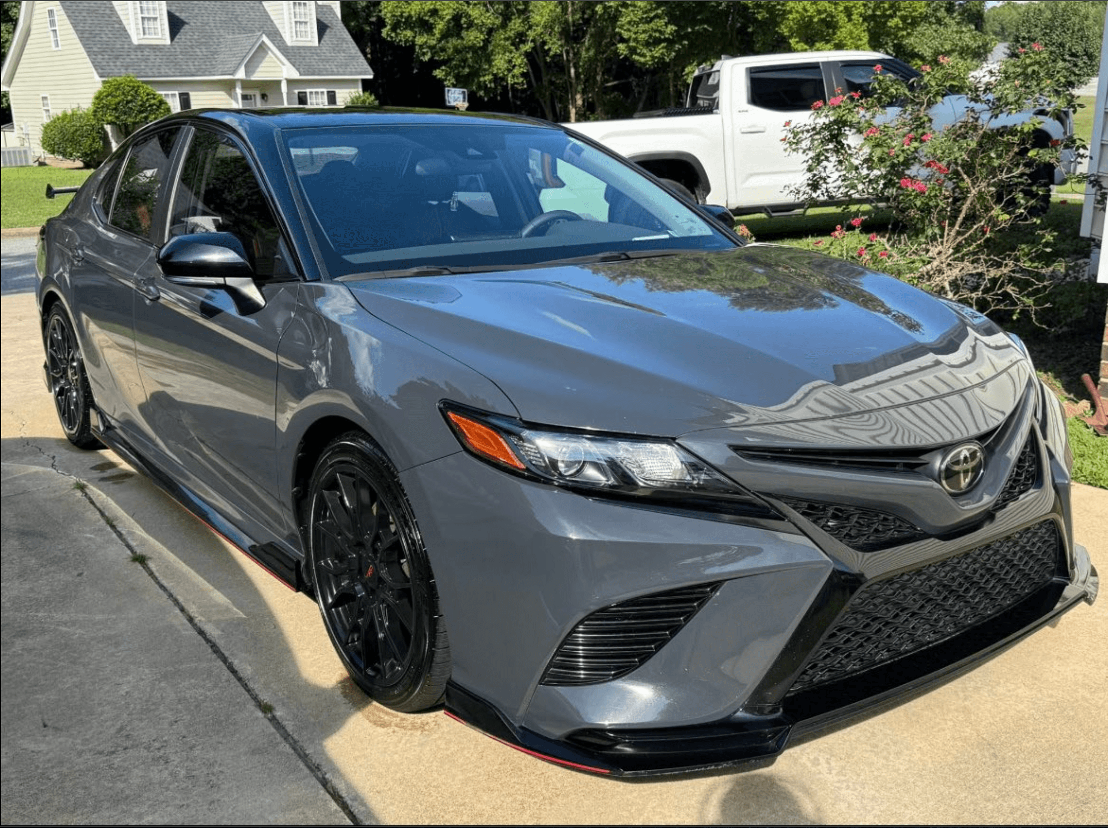 Toyota Camry TRD after a full detail, front three-quarter view in a residential driveway