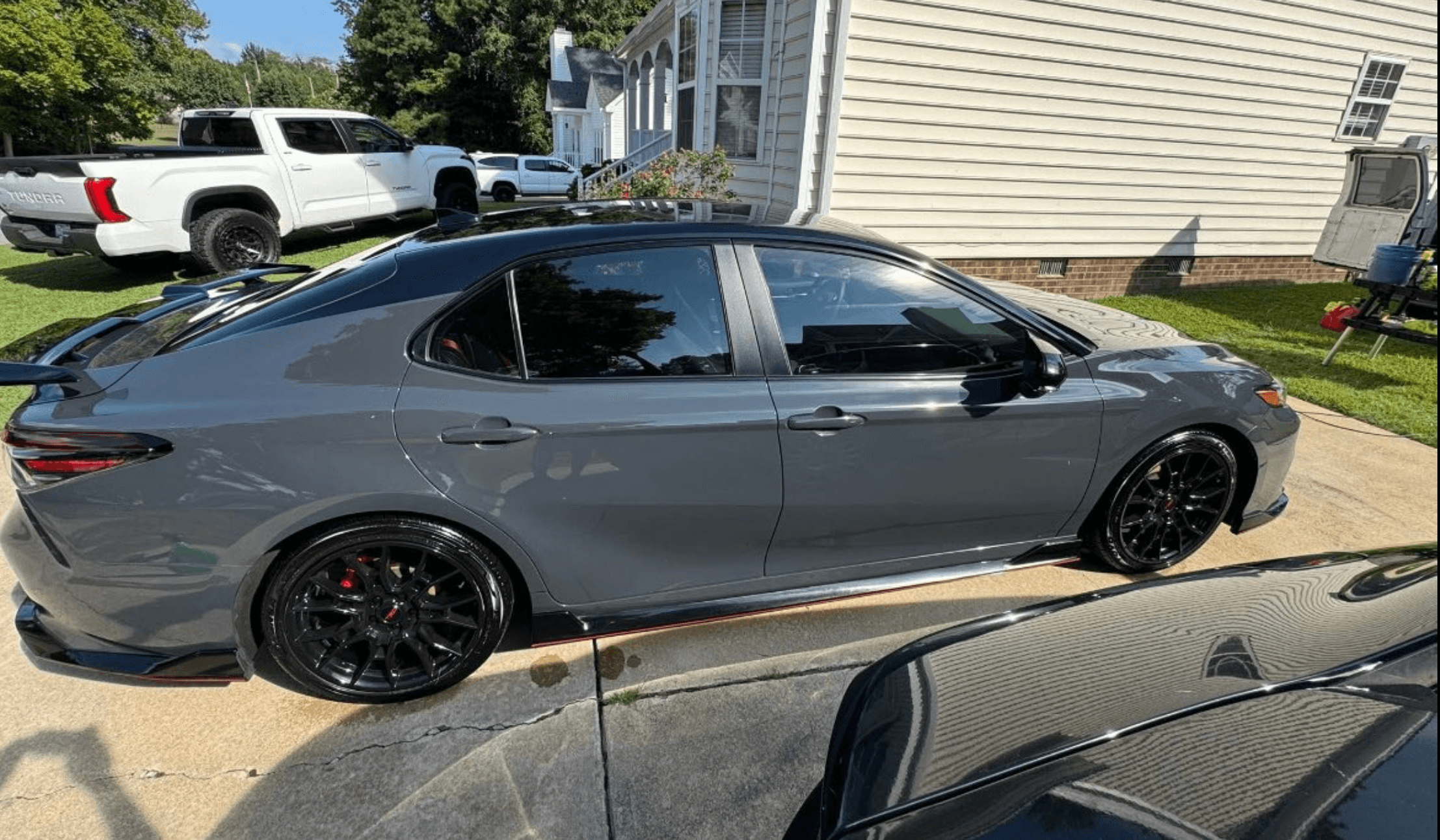 Reflective side panel of a gray Toyota Camry TRD after paint prep — flat gloss with no swirls