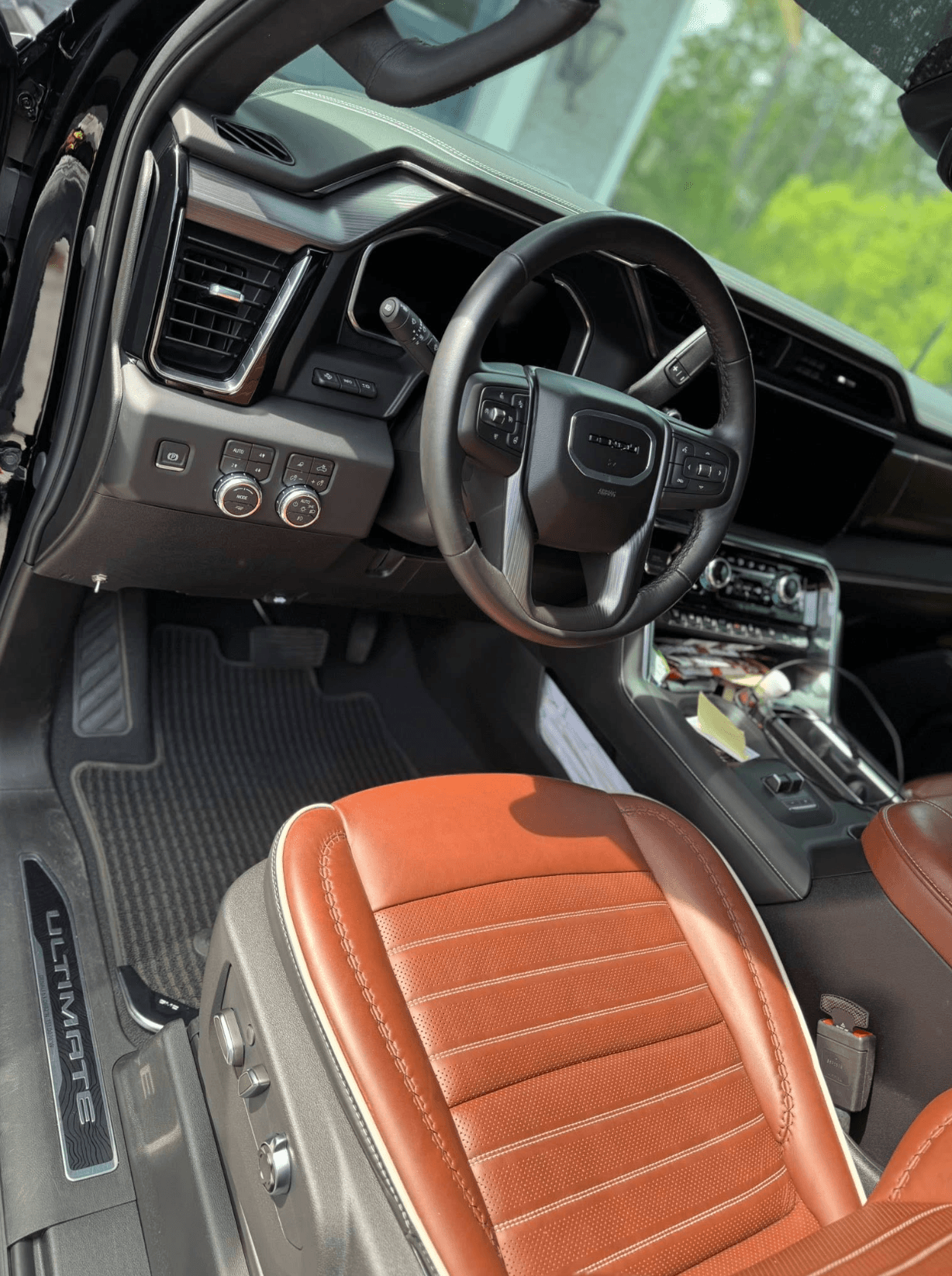 Cleaned GMC Sierra Ultimate cabin with cognac leather seats and detailed dashboard